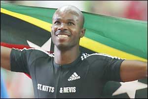 Kim Collins celebrates winning the 100m