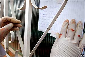 A doctor puts a list of the wounded on a window outside the Hospital Sagrado Corazon de Jesus in El Alto