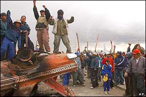 Protesters shout slogans against the Bolivian government on a road blockade near a gas plant in El Alto