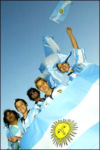 Argentina fans stand behind their flag