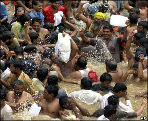 Pilgrims take a dip in the waters of the Godavari river which are regarded to be holy