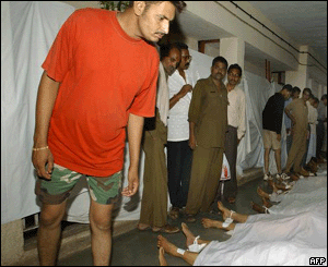 Hindu devotee Amit Goel searches for his missing uncle among dead bodies of stampede victims kept at the Nasik hospital