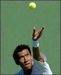 Paradorn Srichaphan of Thailand serves to Dominik Hrbaty of Slovakia