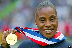 Kelli White celebrates getting her second gold medal of the championships