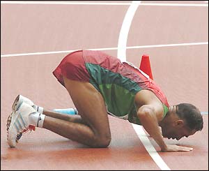 Morocco's Jaouad Gharib kisses the track after winning the men's marathon