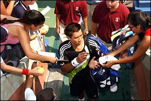 Thailand's Paradorn Srichaphan signs some autographs after beating Fernando Verdasco