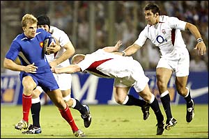 French winger Aurelien Rougerie tries to break away from the tackle of English centre Mike Tindall
