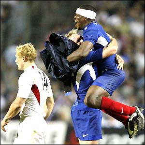 French full-back Brian Liebenberg and flanker Serge Betsen celebrate after their 17-16 win
