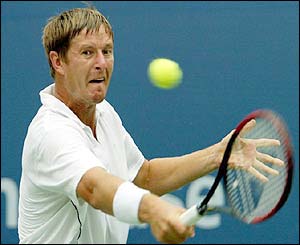 Russia's Yevgeny Kafelnikov plays a backhand