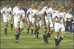 A dejected England leave the pitch after losing to France
