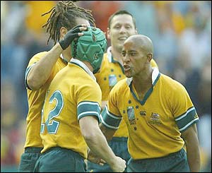 Australia's Elton Flatley is congratulated after scoring 