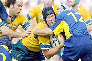 Australian lock Daniel Vickerman crashes into Romanian captain Romeo Gontineac 