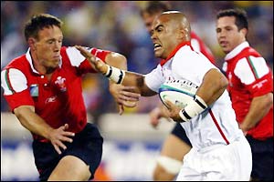 Sililo Martens tries to charge the Wales defence