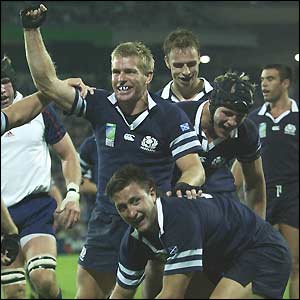 Glenn Metcalfe celebrates with try-scorer Simon Danielli
