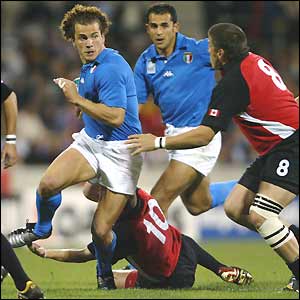 Italy's Manuel Dallan evades Canada's defensive efforts 