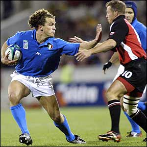 Italy's flanker Aaron Persico hands-off a Canadian challenge