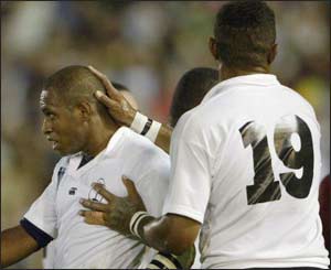 Fiji's Norman Ligairi is congratulated by team-mates