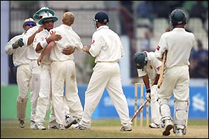 England congratulate Gareth Batty (centre) on the wicket of Habibul Bashar