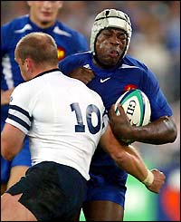France's Serge Betsen runs at the Scottish defence