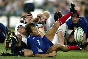 France's Fabien Galthie is tackled by the Scottish defence