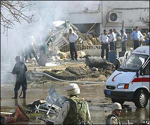 Smoke rises from scene of blast at ICRC building in Baghdad as Iraqis and US soldiers search through debris
