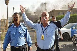 Iraqi police wave back bystanders following ICRC blast 