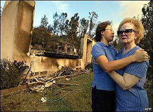 A woman is consoled after her house is destroyed in San Bernadino
