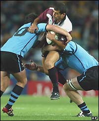 Georgian fly-half Paliko Jimsheladze tries to break a tackle after missing two early penalty chances