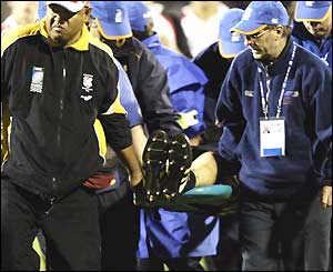 Canadian captain Al Charron is stretchered off in his last international