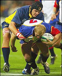 Wolfie Duvenhage is tackled by Romania's Augustin Petrichei