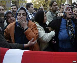 Filiz, the wife of Suleyman Aydogan and his mother Meral, mourn at his coffin at a ceremony in Istanbul, Turkey