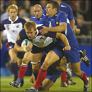 Flanker Kort Schubert barges through a tackle on the attack for the USA