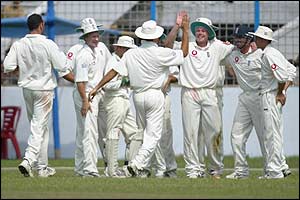 Martin Saggers is congratulated by his team-mates after his catch dismisses Alok Kapali 