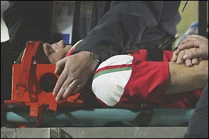 Evans is stretched off after a collision with his captain