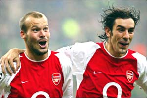 Freddie Ljungberg celebrates with Robert Pires after scoring three minutes after the break
