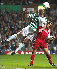 John Hartson of Celtic jumps with Bayern's Bixente Lizarazu 