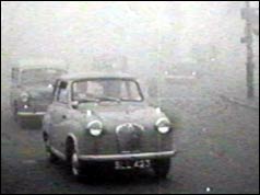 Car driving through fog