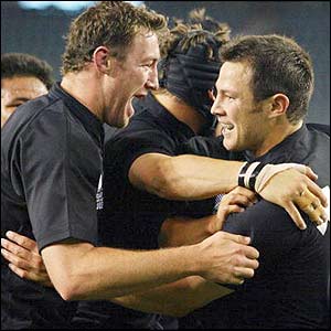 Leon MacDonald (r) is congratulated after scoring the only try of the first half