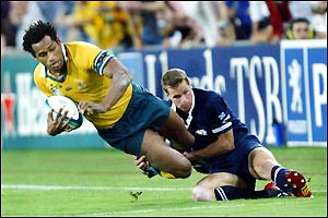 Australia's Lote Tuqiri is stopped by Scotland's Chris Paterson