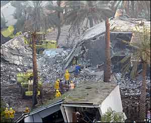 Rescuers pick through the rubble at the Muhaya compound