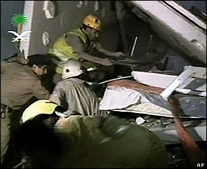 Television footage shows rescuers searching through the rubble 