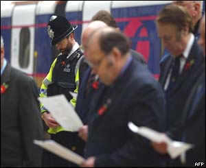 Commuters and a British policeman at Paddington Station