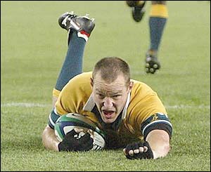 Australia's Stirling Mortlock skids over to score a try