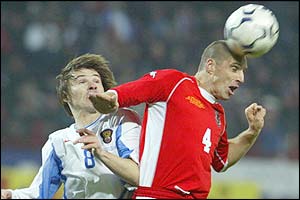 Dmitry Loskov battles for the ball with Wales' Andy Melville