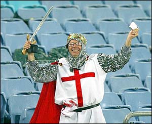 An England fan dressed as a medieval solider celebrates victory