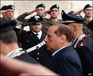 Italian Prime Minister Silvio Berlusconi passing next to the slain Italian soldiers and police men which have been laying in state