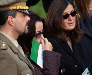 Relatives of the 19 Italians slain in Iraq mourn as the caskets are carried inside St Paul Basilica