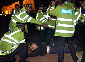 Police wrestle a protester to the ground