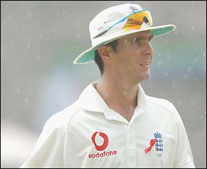 England captain Michael Vaughan leaves the field as rain falls