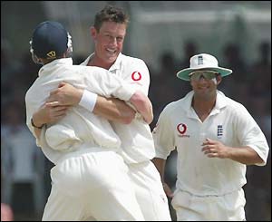 Ashley Giles (centre) celebrates taking his third wicket of the innings